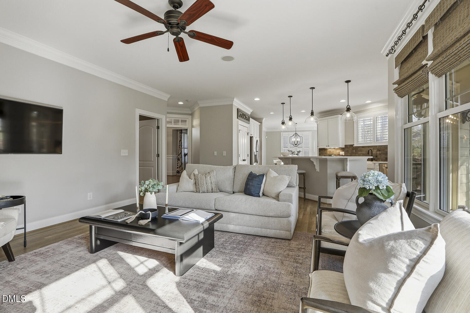 3124 Briar Stream Run Raleigh, NC 27612 - Photo 27 of 57 a living room with furniture a flat screen tv and kitchen view