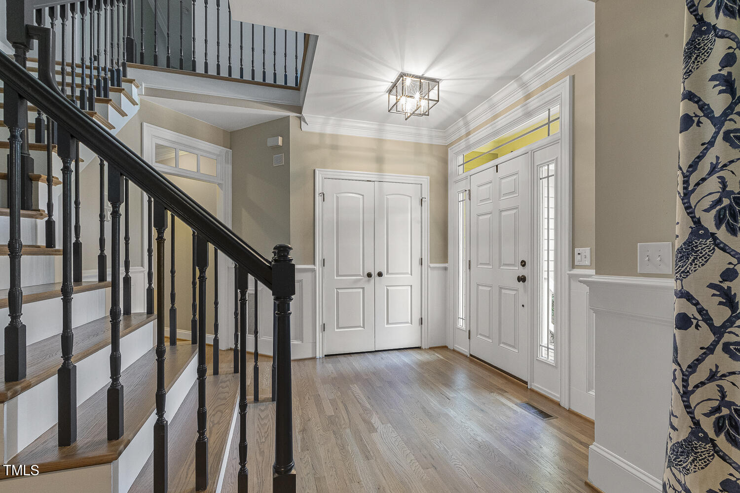 3124 Briar Stream Run Raleigh, NC 27612 - Photo 3 of 57 a view of a hallway with wooden floor and staircase