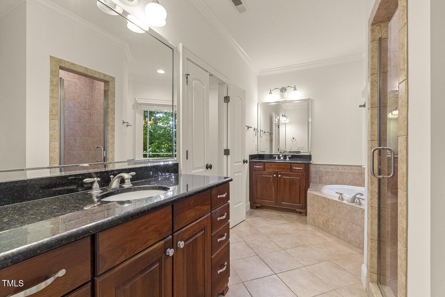 3124 Briar Stream Run Raleigh, NC 27612 - Photo 39 of 57 a bathroom with a granite countertop double vanity sink a mirror and a bathtub