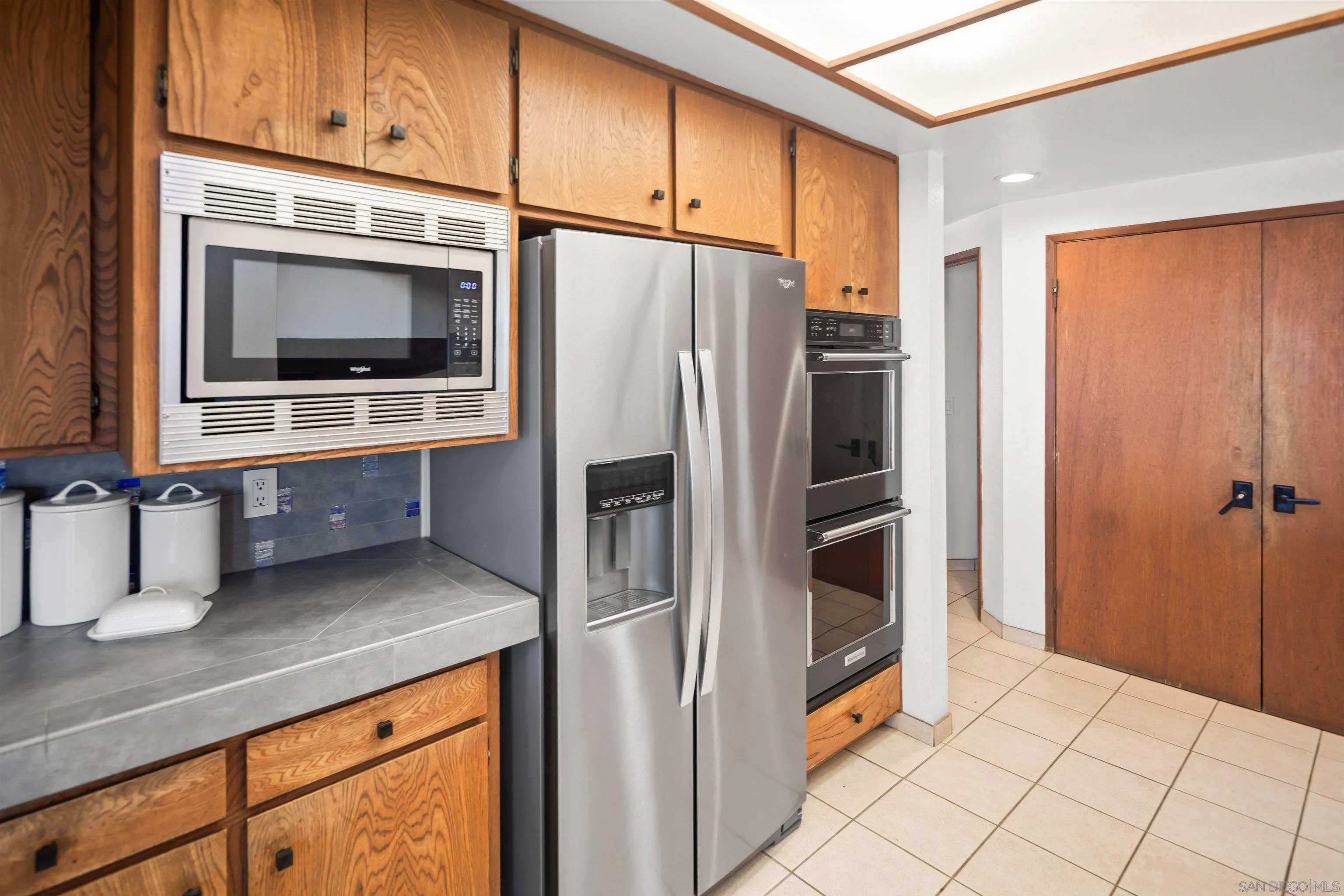 1005 Cornish Drive San Diego, CA 92107 - Photo 20 of 71 a kitchen with stainless steel appliances a refrigerator and a stove top oven