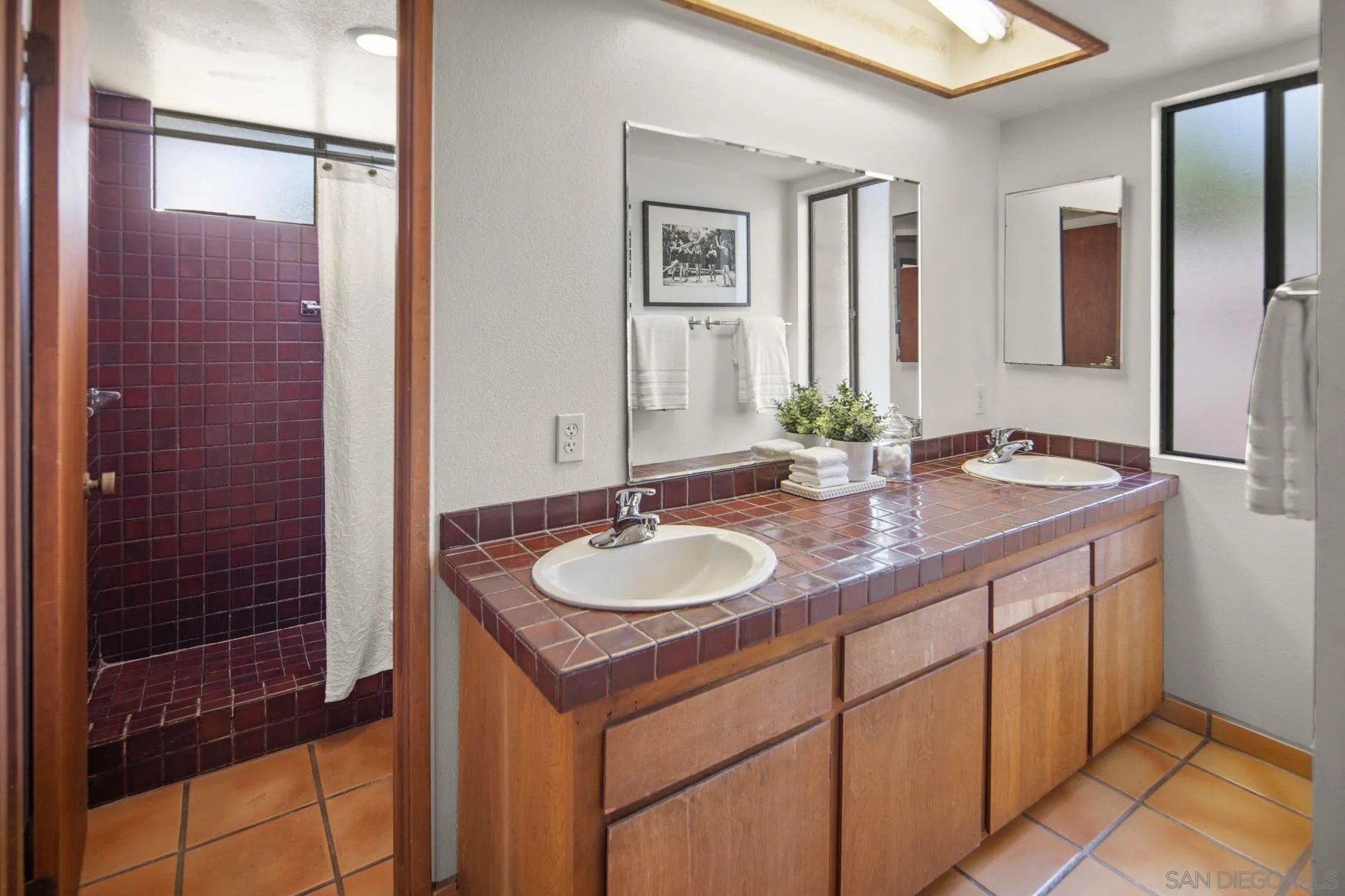 1005 Cornish Drive San Diego, CA 92107 - Photo 41 of 71 a bathroom with a granite countertop sink and a mirror