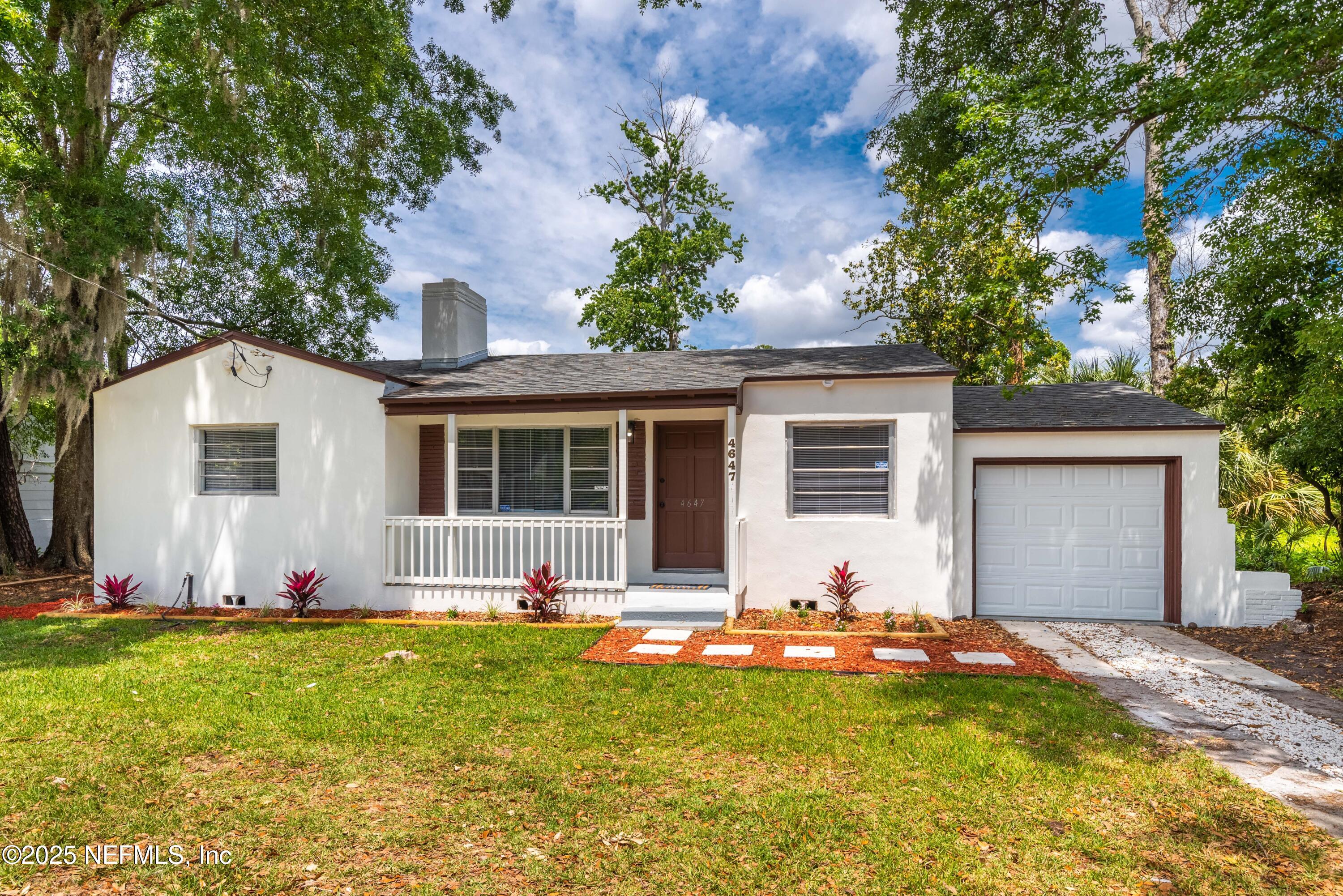 a view of a house with swimming pool and a yard