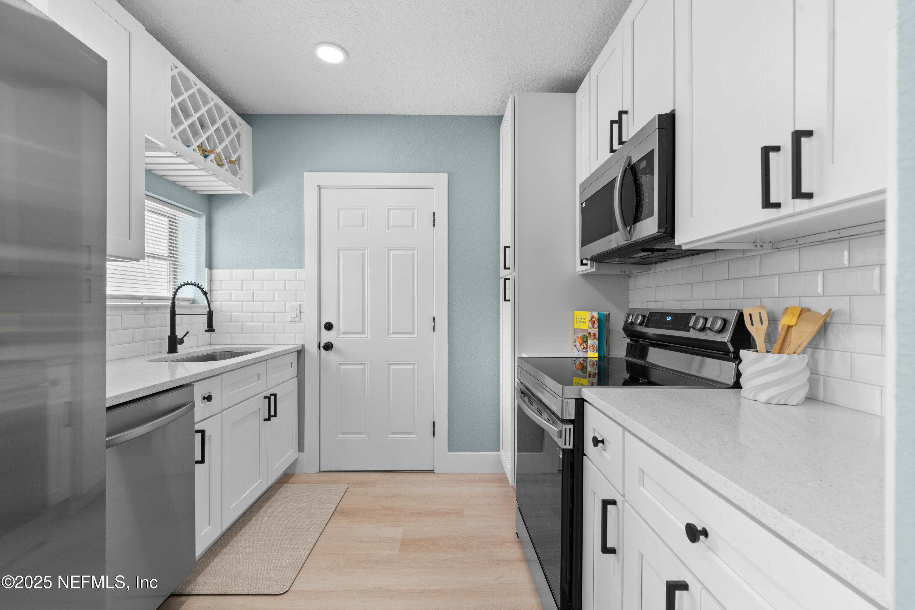 4647 Timuquana Road Jacksonville, FL 32210 - Photo 13 of 27 a kitchen with stainless steel appliances granite countertop a sink and a stove
