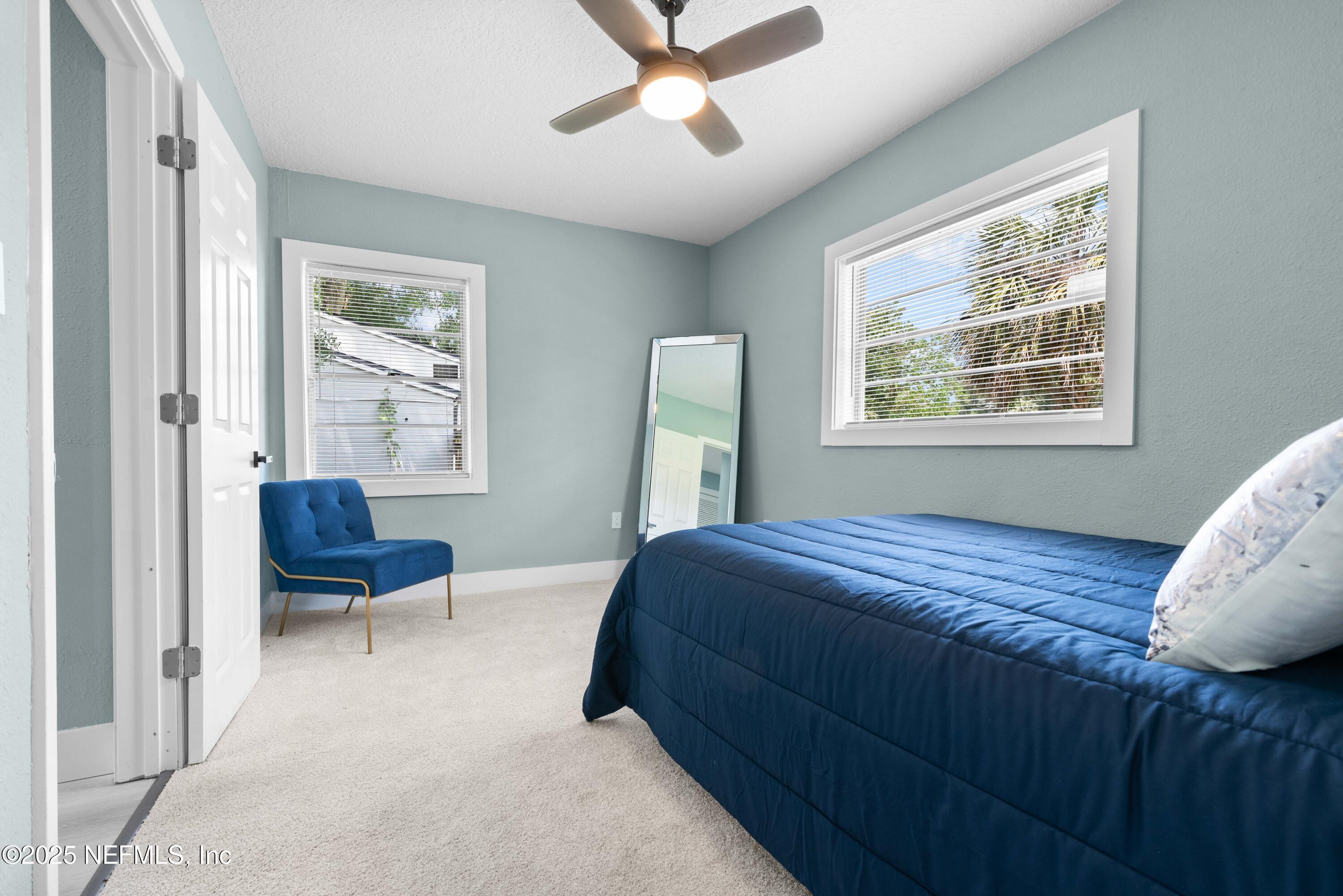 4647 Timuquana Road Jacksonville, FL 32210 - Photo 15 of 27 a bedroom with a bed and a chair