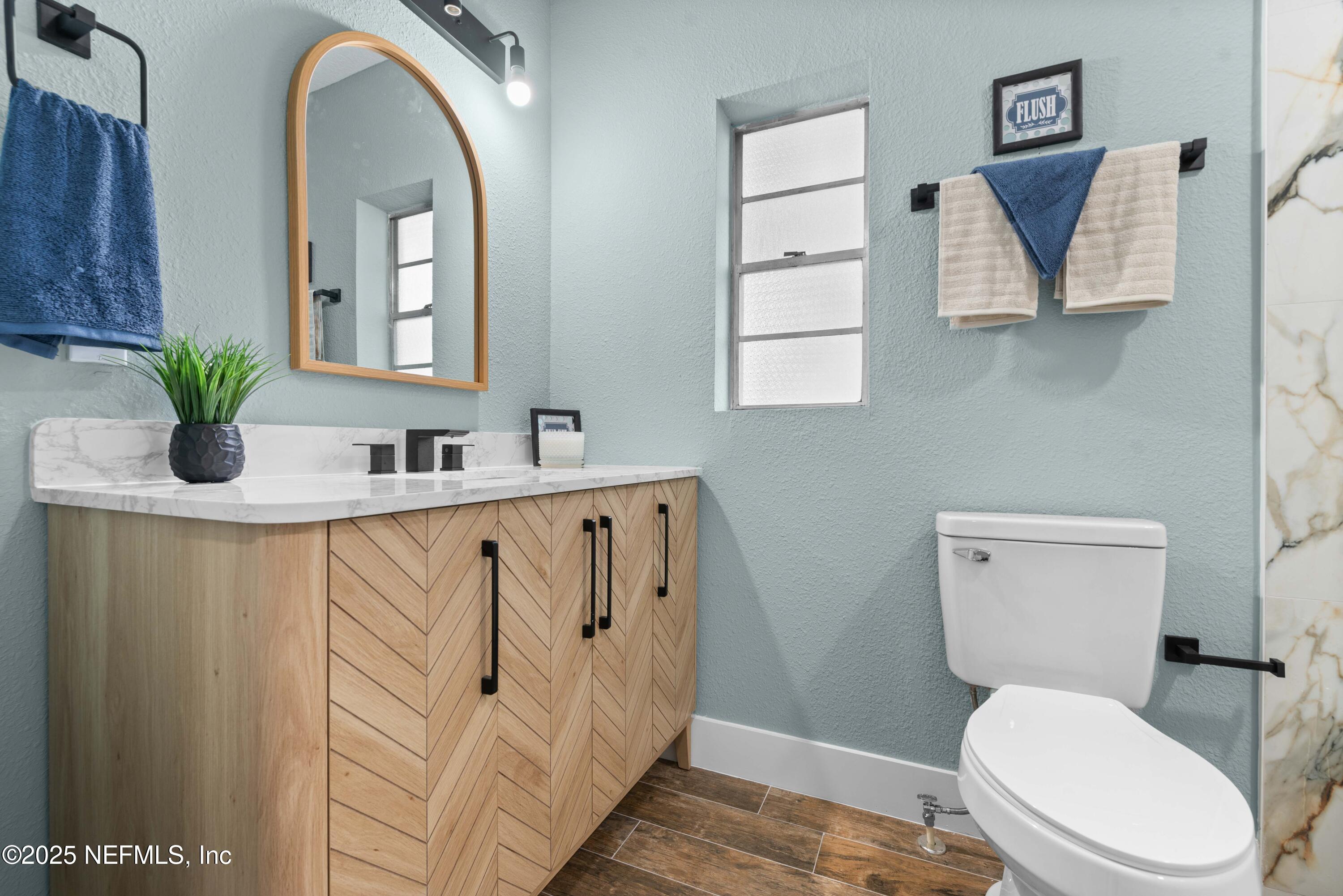 4647 Timuquana Road Jacksonville, FL 32210 - Photo 19 of 27 a white toilet sitting next to a bathroom sink