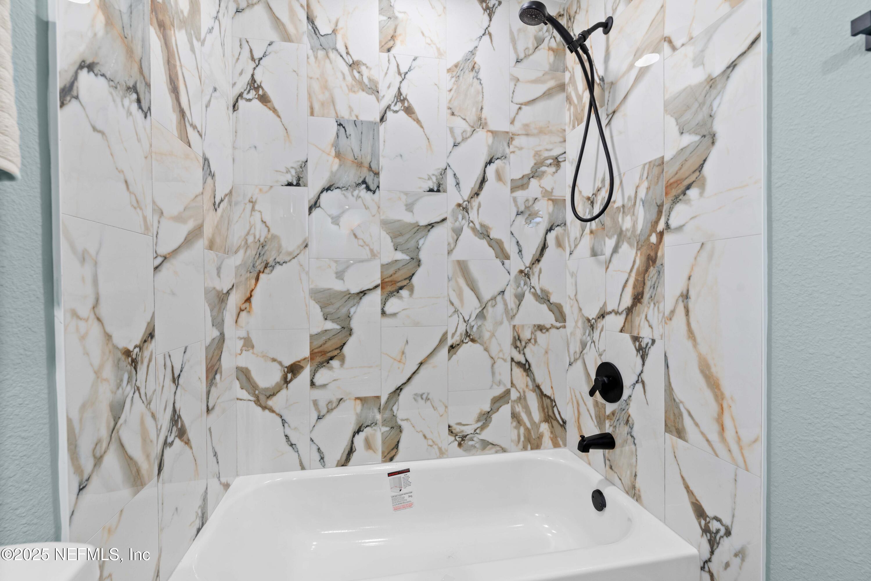 4647 Timuquana Road Jacksonville, FL 32210 - Photo 20 of 27 a bathroom with a bathtub and shower