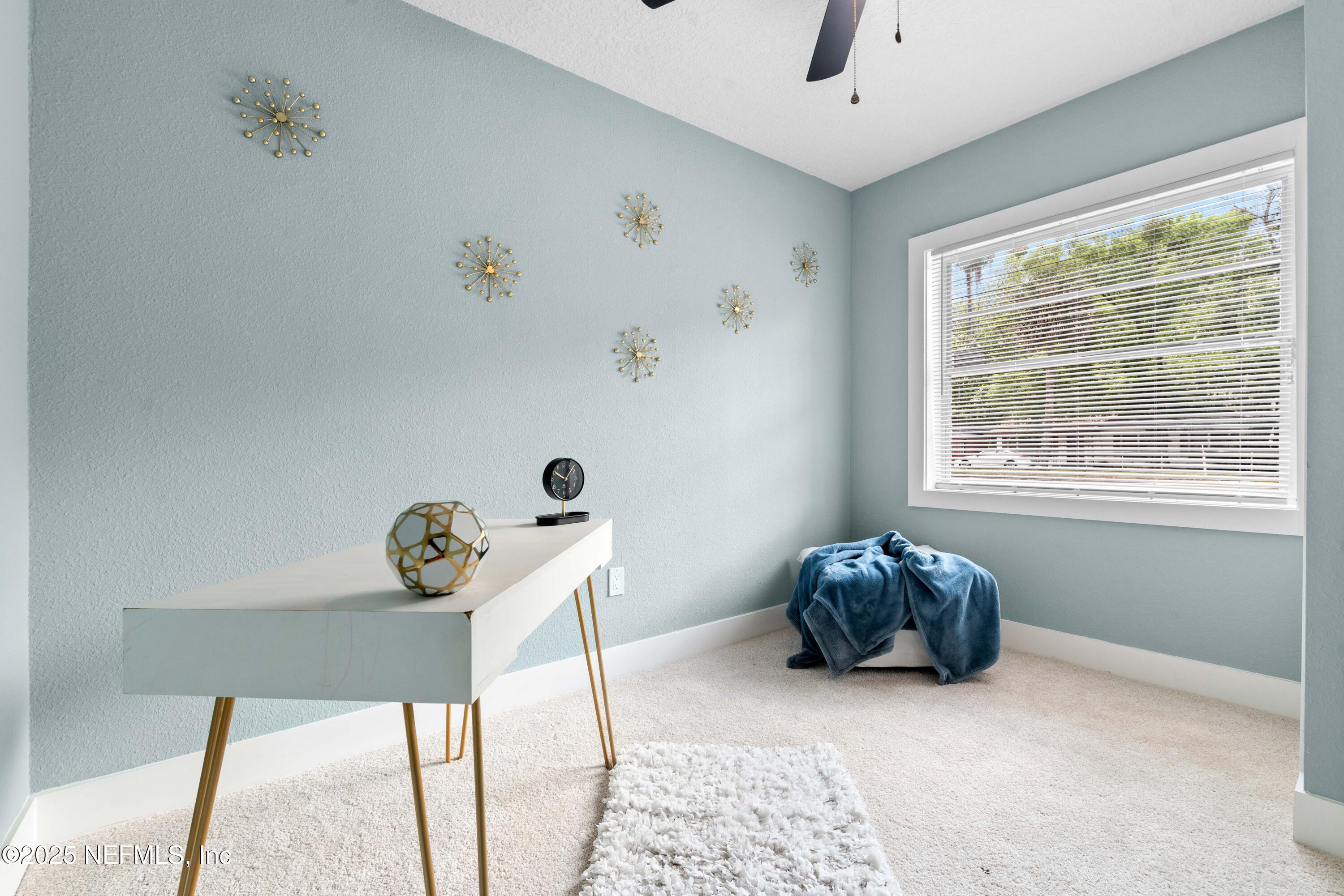 4647 Timuquana Road Jacksonville, FL 32210 - Photo 21 of 27 a room with a window and a chandelier