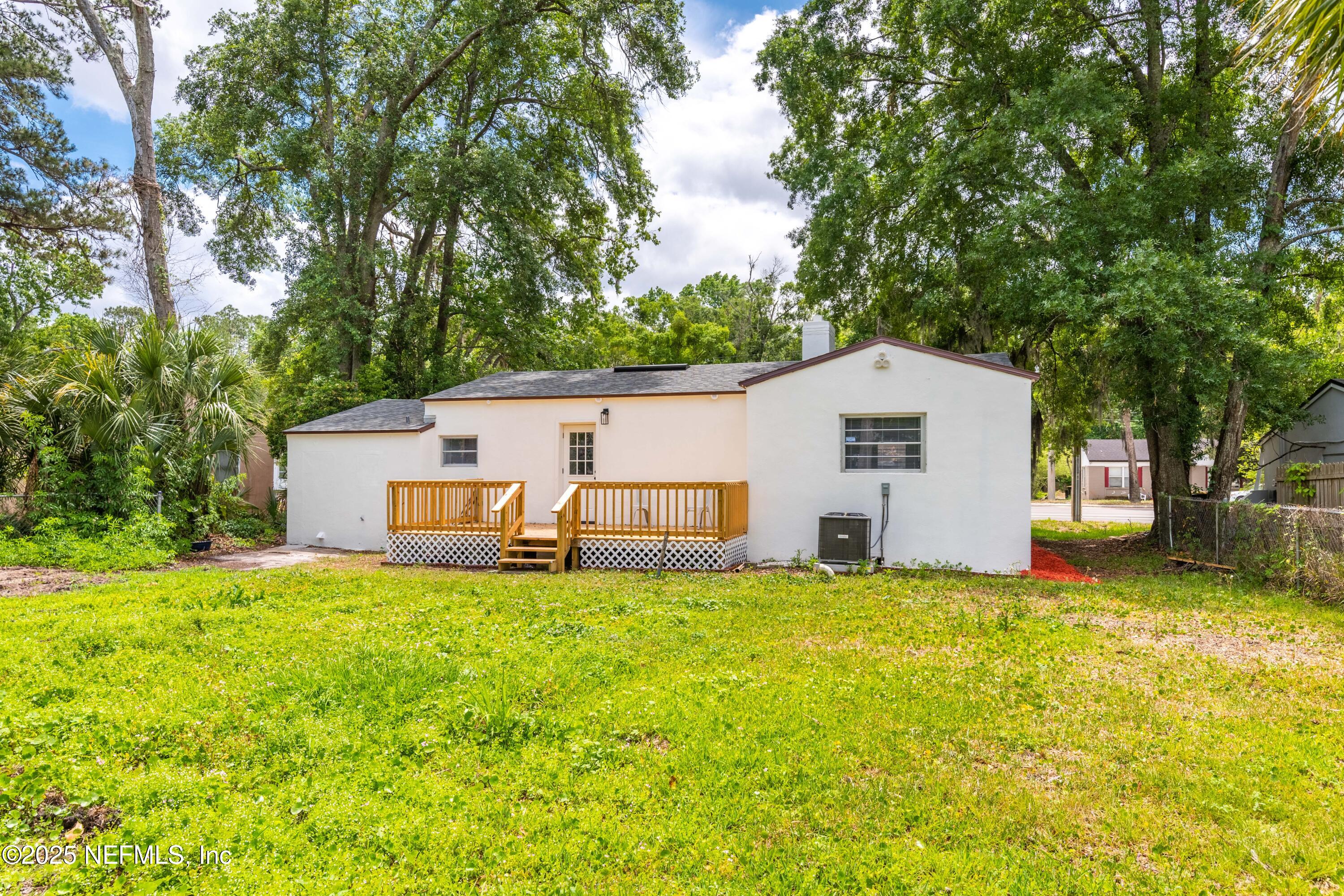 4647 Timuquana Road Jacksonville, FL 32210 - Photo 27 of 27 a house with a big yard and large trees