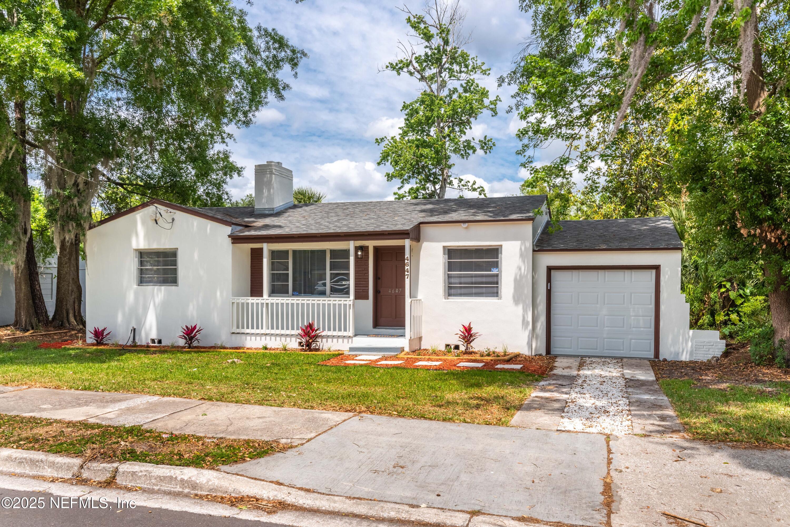 4647 Timuquana Road Jacksonville, FL 32210 - Photo 3 of 27 a front view of a house with a yard and garage