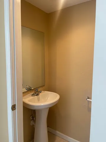 a bathroom with a sink and mirror