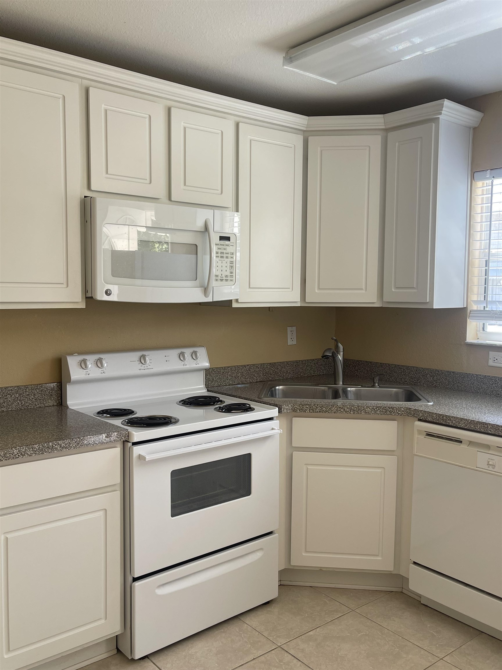 4420 Carter Road, Unit 41 St. Augustine, FL 32086 - Photo 10 of 10 a kitchen with white cabinets and white appliances