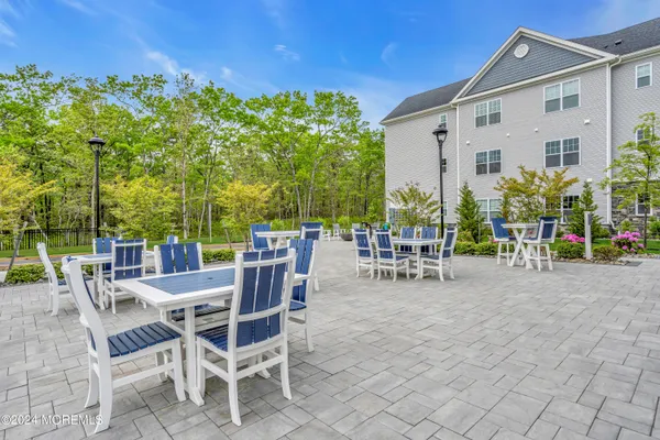 a view of a patio with a table and chairs