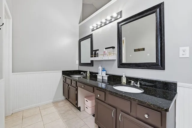 a bathroom with a granite countertop sink a vanity and a mirror