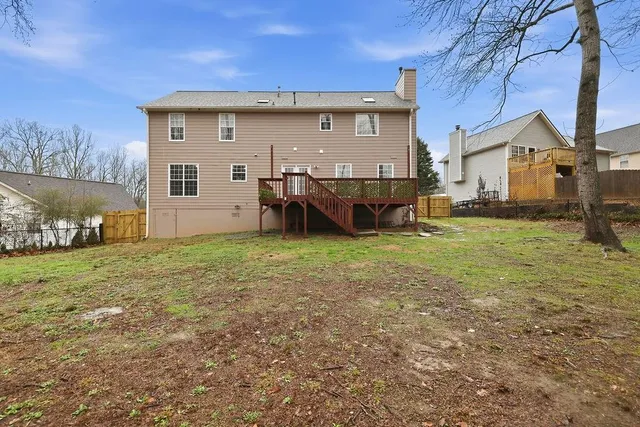 a view of a house with a yard and sitting area