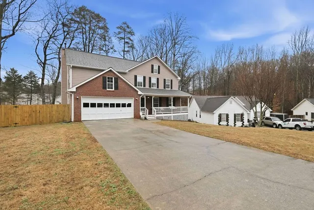 a front view of a house with a yard and garage