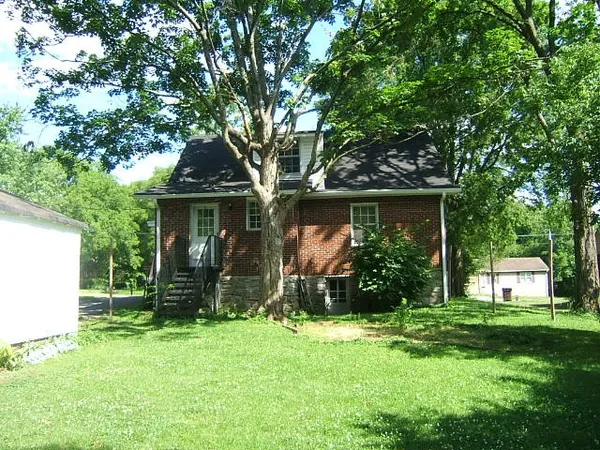 front view of a house with a tree in a yard