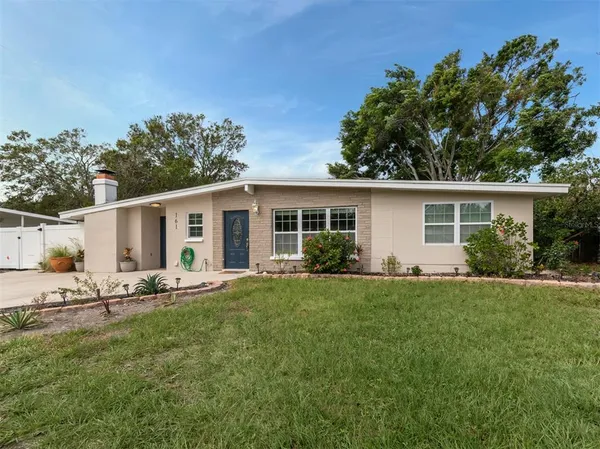 a front view of house with a garden and patio