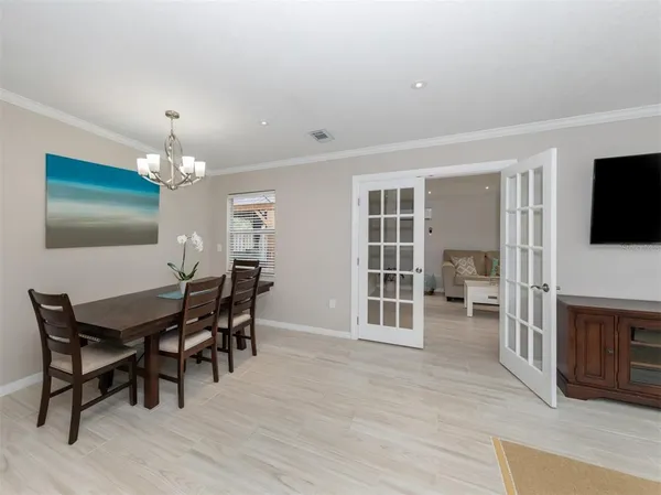 a view of a dining room with furniture and chandelier