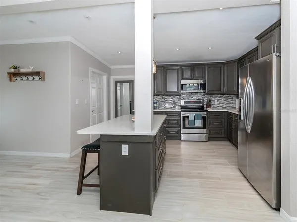 a kitchen with stainless steel appliances granite countertop a stove refrigerator and oven