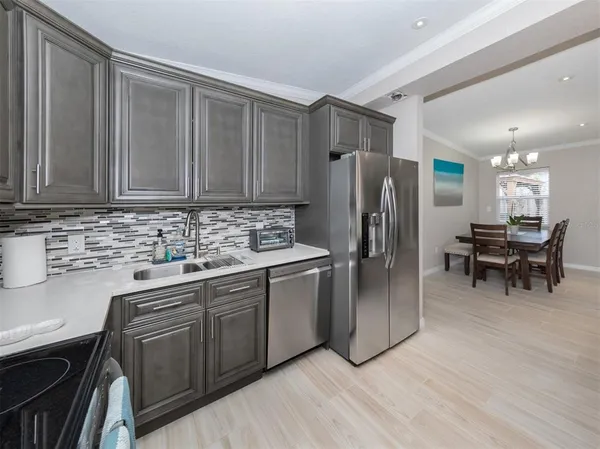 a kitchen with stainless steel appliances granite countertop a refrigerator sink and cabinets
