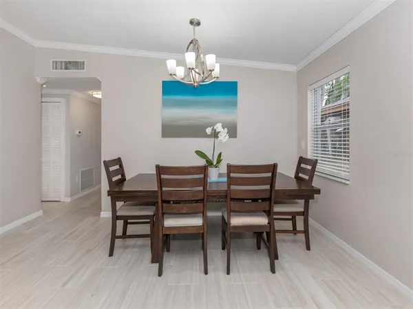 a dining room with furniture and window