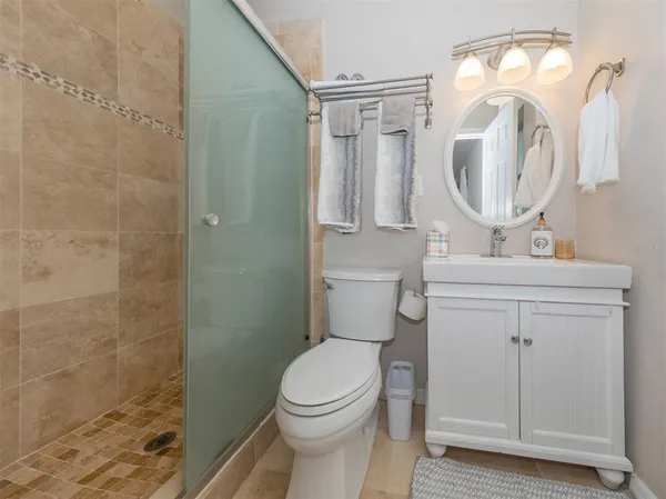 a bathroom with a toilet a sink and a mirror
