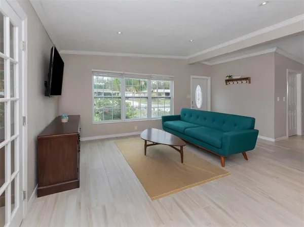 a living room with a flat screen tv and a couch