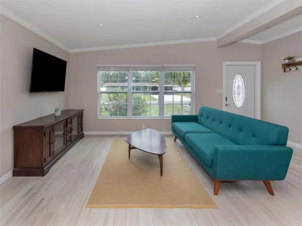 a living room with furniture and a flat screen tv