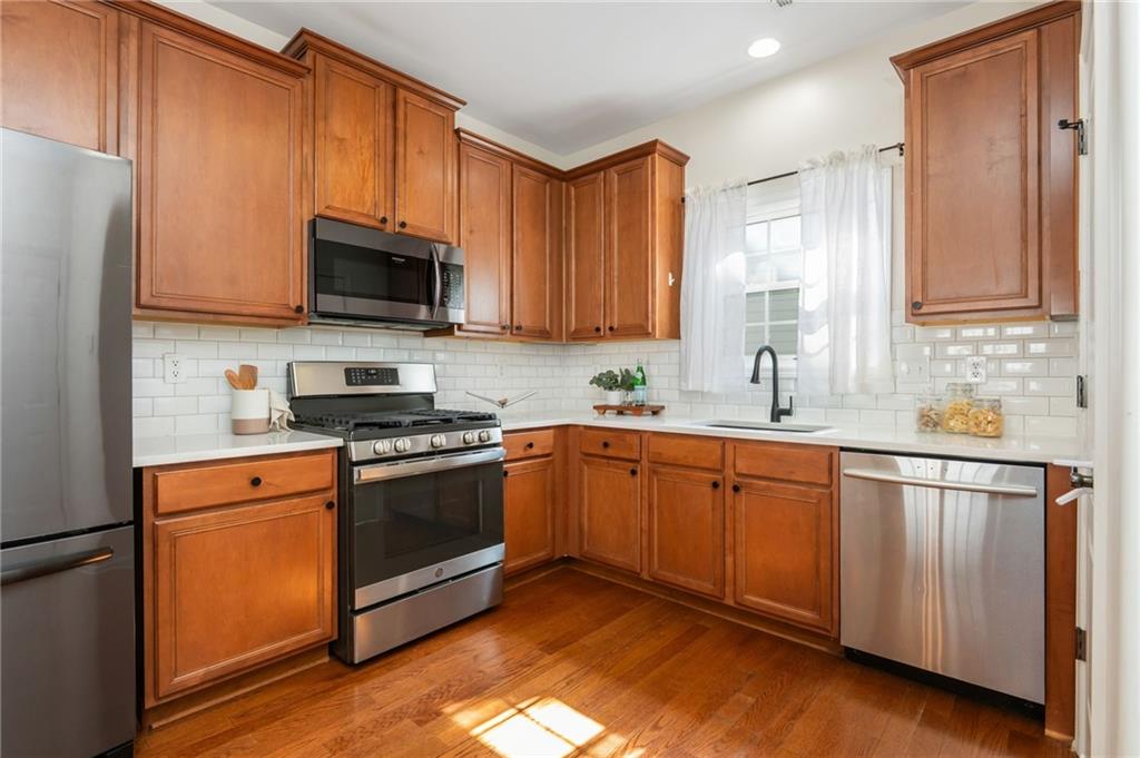 4150 Lake Pass Lane Suwanee, GA 30024 - Photo 20 of 46 a kitchen with stainless steel appliances granite countertop a stove a sink and a microwave
