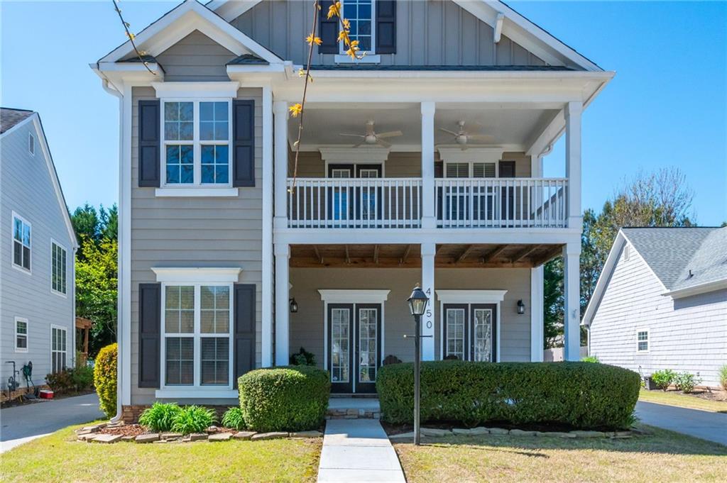 4150 Lake Pass Lane Suwanee, GA 30024 - Photo 2 of 46 a view of a house with brick walls and porch with plants