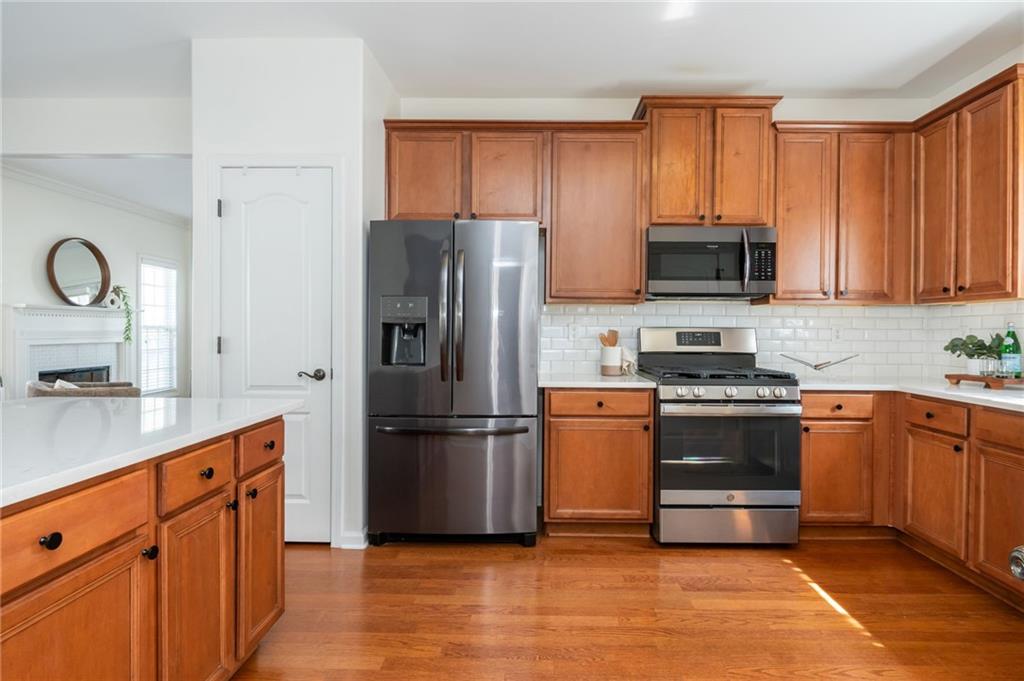 4150 Lake Pass Lane Suwanee, GA 30024 - Photo 22 of 46 a kitchen with stainless steel appliances granite countertop a refrigerator stove top oven a sink and dishwasher