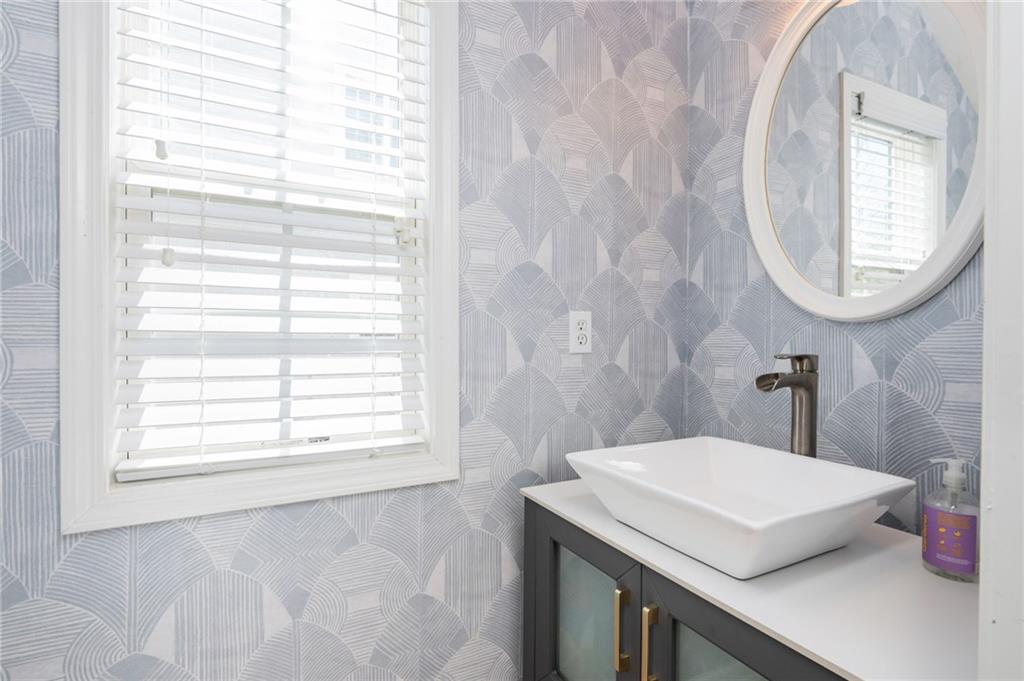 4150 Lake Pass Lane Suwanee, GA 30024 - Photo 23 of 46 a bathroom with a sink a mirror and a window