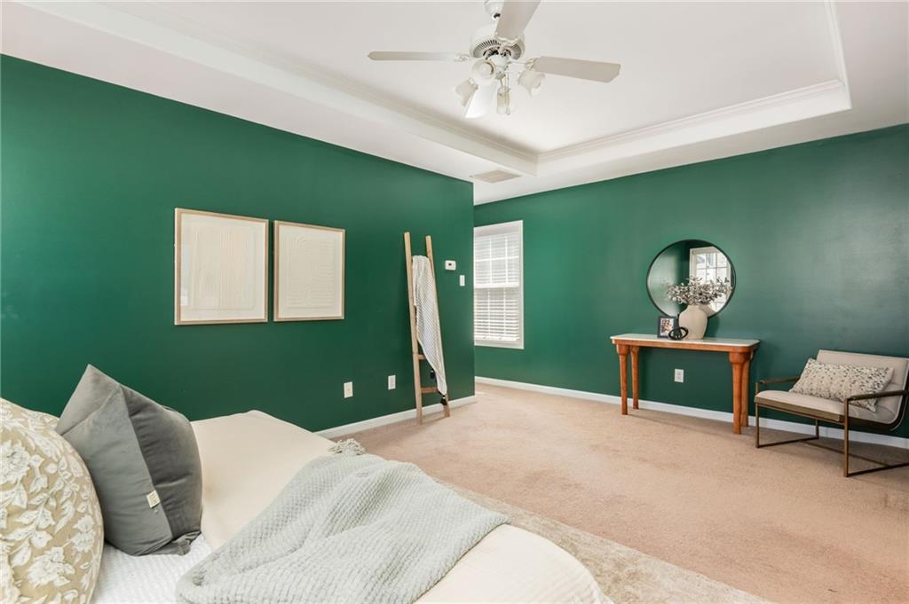4150 Lake Pass Lane Suwanee, GA 30024 - Photo 27 of 46 a bedroom with a bed and a chandelier