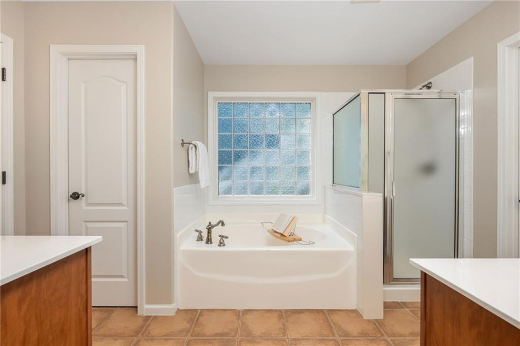 4150 Lake Pass Lane Suwanee, GA 30024 - Photo 28 of 46 a bathroom with a bathtub and a sink