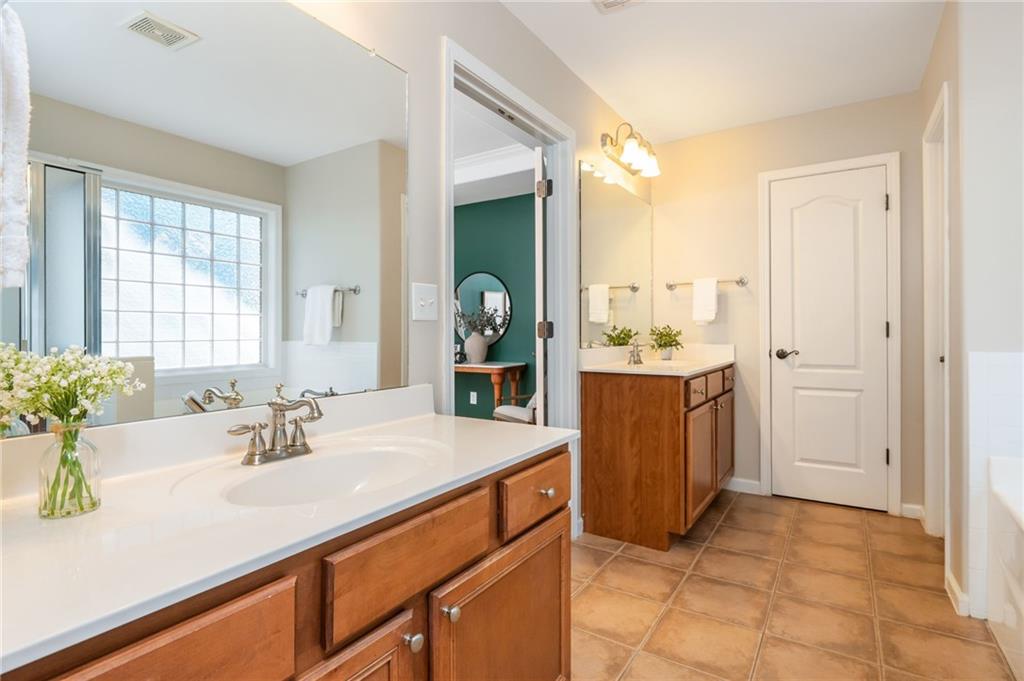 4150 Lake Pass Lane Suwanee, GA 30024 - Photo 31 of 46 a bathroom with a sink and a mirror