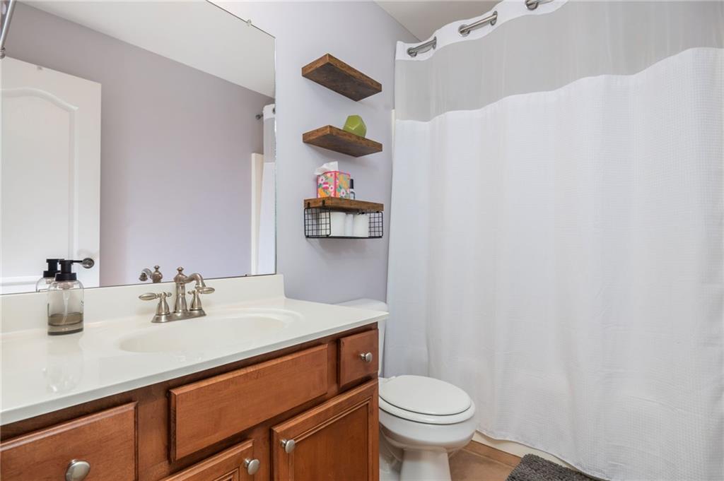 4150 Lake Pass Lane Suwanee, GA 30024 - Photo 34 of 46 a bathroom with a sink vanity mirror and toilet