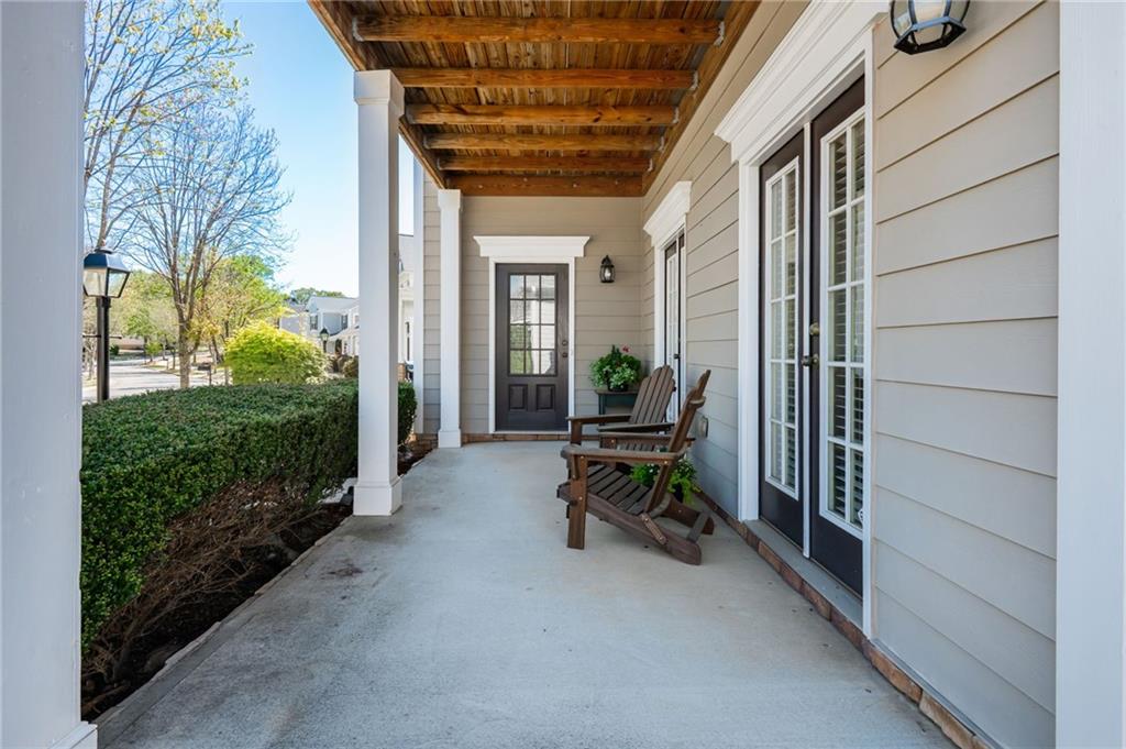 4150 Lake Pass Lane Suwanee, GA 30024 - Photo 42 of 46 a view of a porch with furniture and floor to ceiling window
