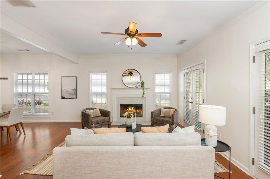 4150 Lake Pass Lane Suwanee, GA 30024 - Photo 7 of 46 a living room with fireplace furniture and a large window