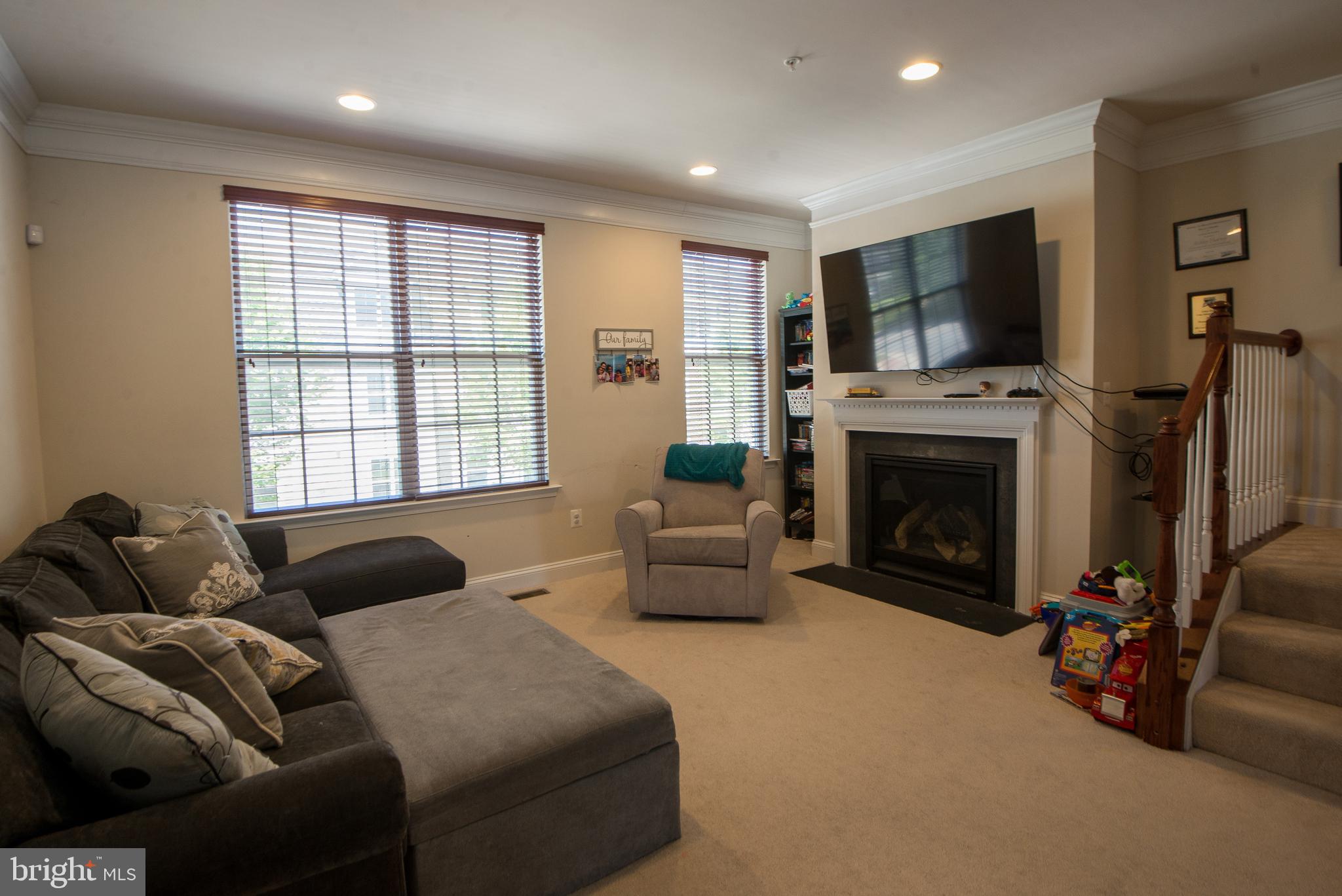 8 Meridian Lane Towson, MD 21286 - Photo 12 of 39 a living room with furniture a flat screen tv and a fireplace