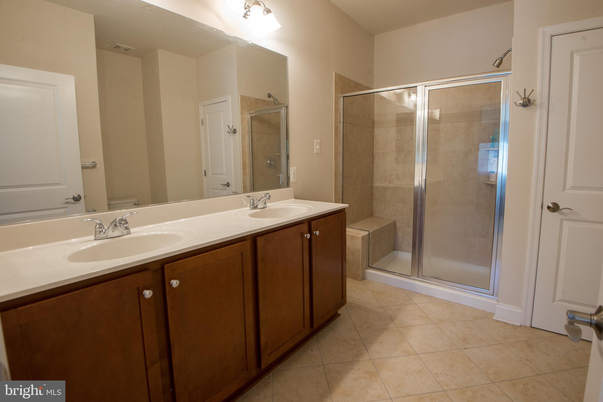 8 Meridian Lane Towson, MD 21286 - Photo 17 of 39 a bathroom with a double vanity sink mirror and shower