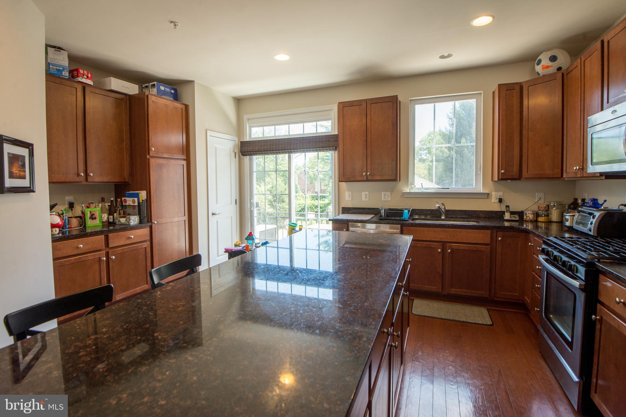 8 Meridian Lane Towson, MD 21286 - Photo 5 of 39 a kitchen with stainless steel appliances granite countertop a stove top oven a sink and a refrigerator