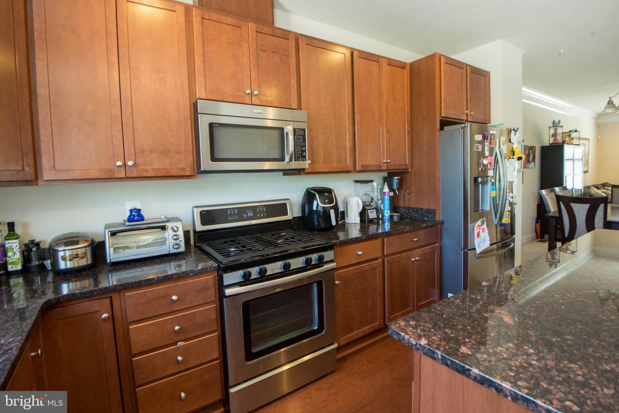 8 Meridian Lane Towson, MD 21286 - Photo 6 of 39 a kitchen with stainless steel appliances granite countertop a stove a sink and a microwave
