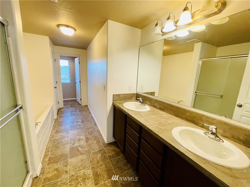 1924 Stevens Street Walla Walla, WA 99362 - Photo 21 of 24 a bathroom with a double vanity sink and a mirror