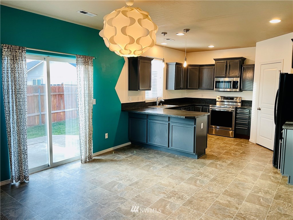 1924 Stevens Street Walla Walla, WA 99362 - Photo 5 of 24 a kitchen with stainless steel appliances granite countertop a sink and cabinets