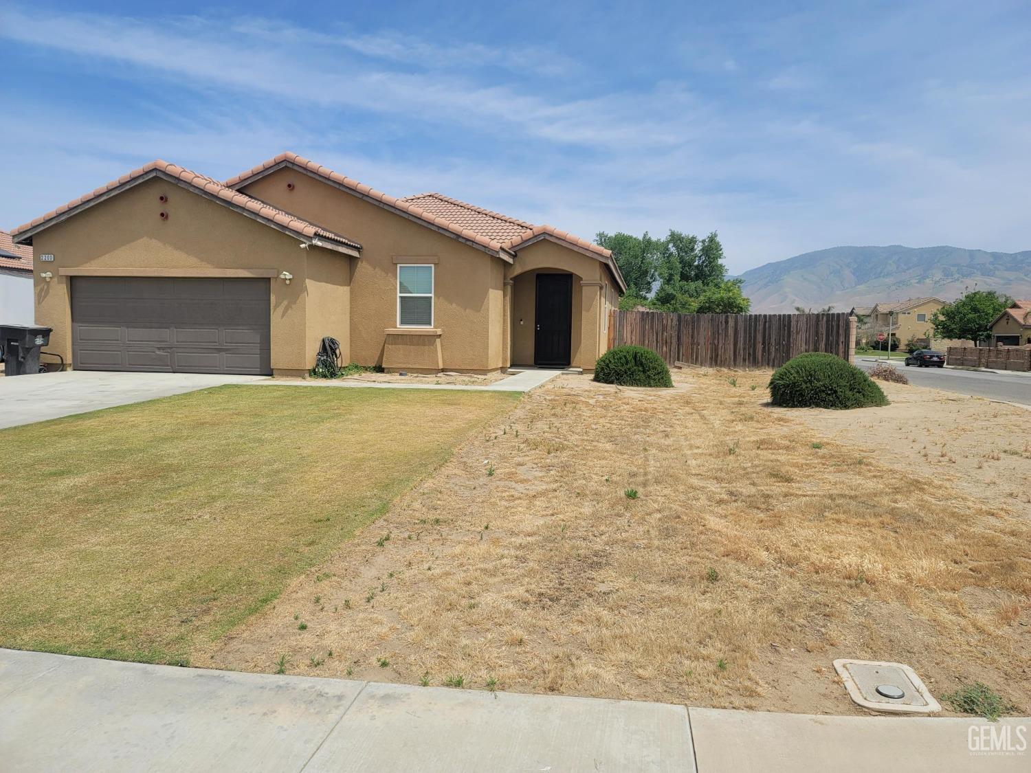 Undisclosed Address Arvin, CA 93203 - Photo 2 of 7 a view of a house with a yard