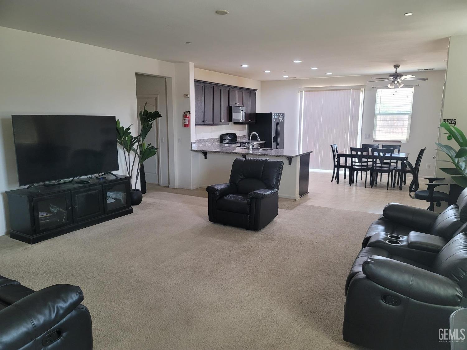 Undisclosed Address Arvin, CA 93203 - Photo 3 of 7 a living room with furniture and a flat screen tv