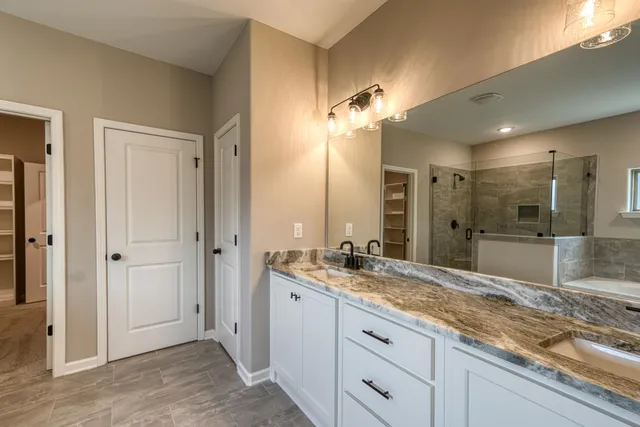 a bathroom with a granite countertop sink mirror and double