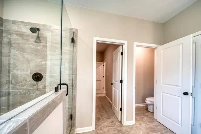 a spacious bathroom with a shower and a sink