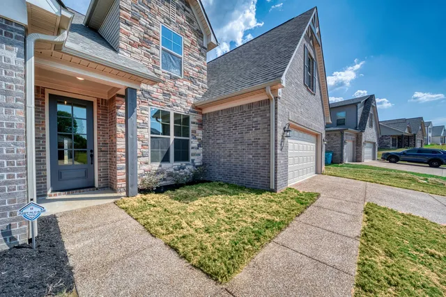 a view of a brick house with many windows