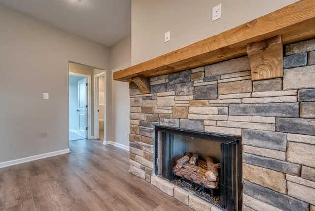 a hallway with fireplace and wooden floor